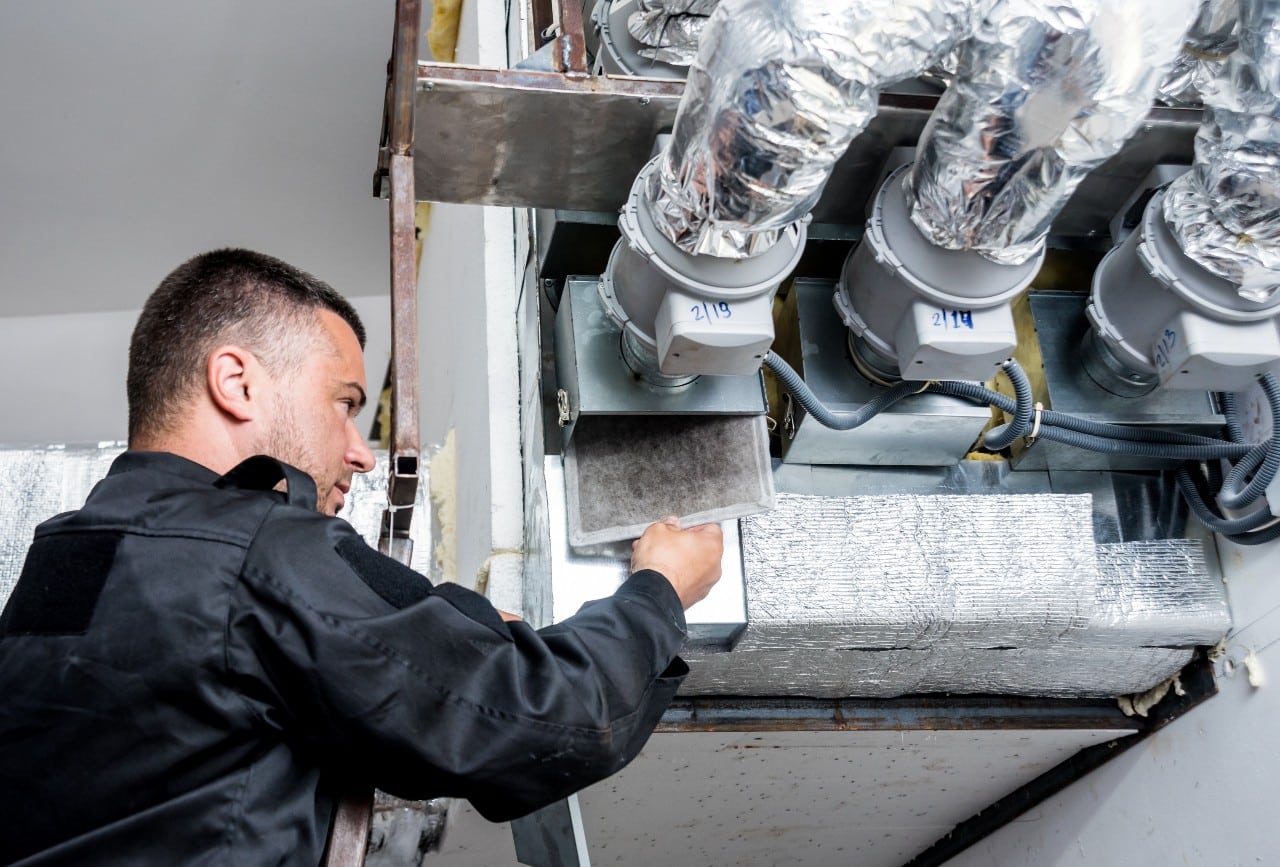 Ventilation cleaning. Specialist at work. Repair ventilation system (HVAC)